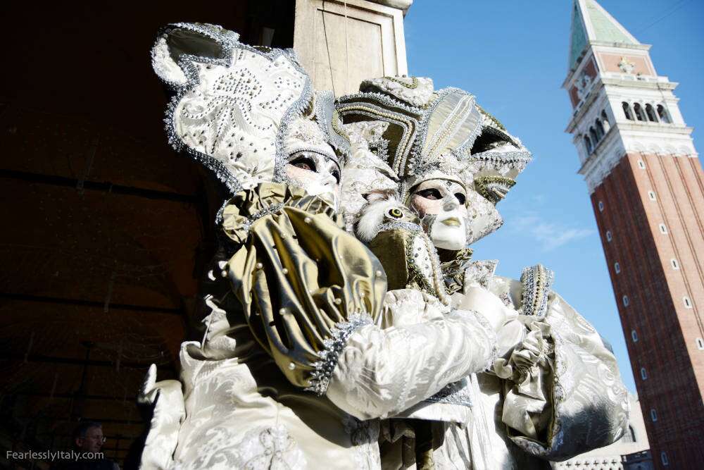 Image: Masks of the Carnival of Venice with San Marco Basilica background.